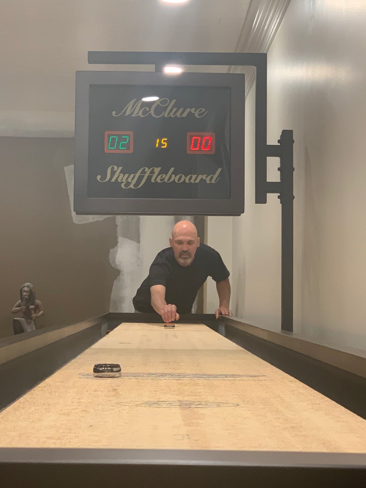 Man playing shuffleboard during a casual social gathering
