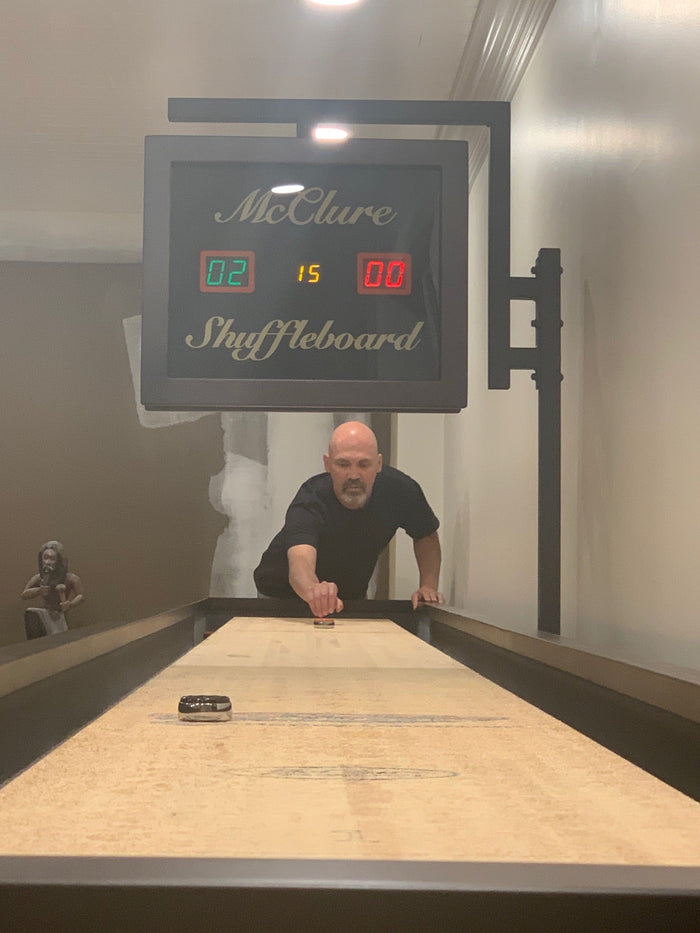 Man playing shuffleboard during a casual social gathering