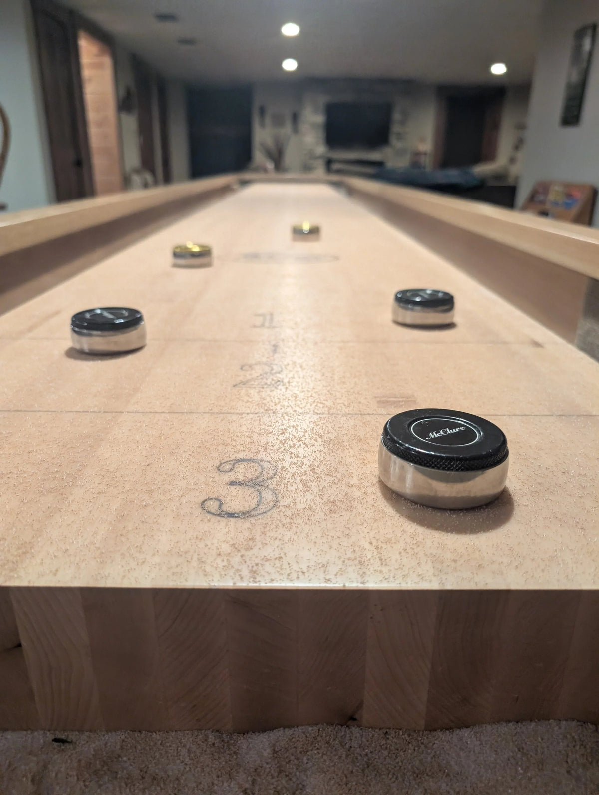 table shuffleboard near and far foul line marked on table with puck release position
